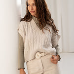 Organic cotton turtleneck in green whit a knit vest in ecru. Made in Portugal.