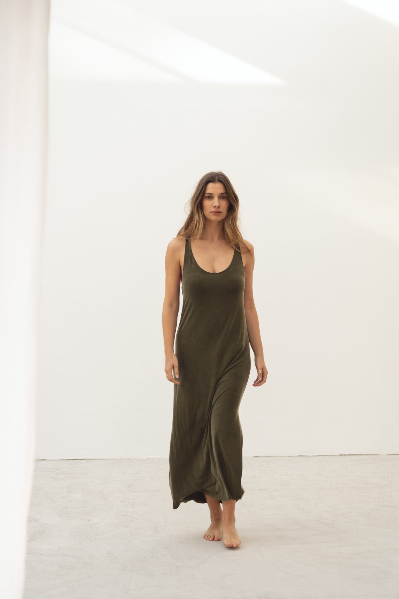 Naz women's midi dress made with silky cupro in dark green. With a side slit cross over back. 