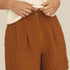 Naz women's breathable linen summer shorts in rust. High-waisted relaxed wide fit with hidden pockets. Made in Portugal