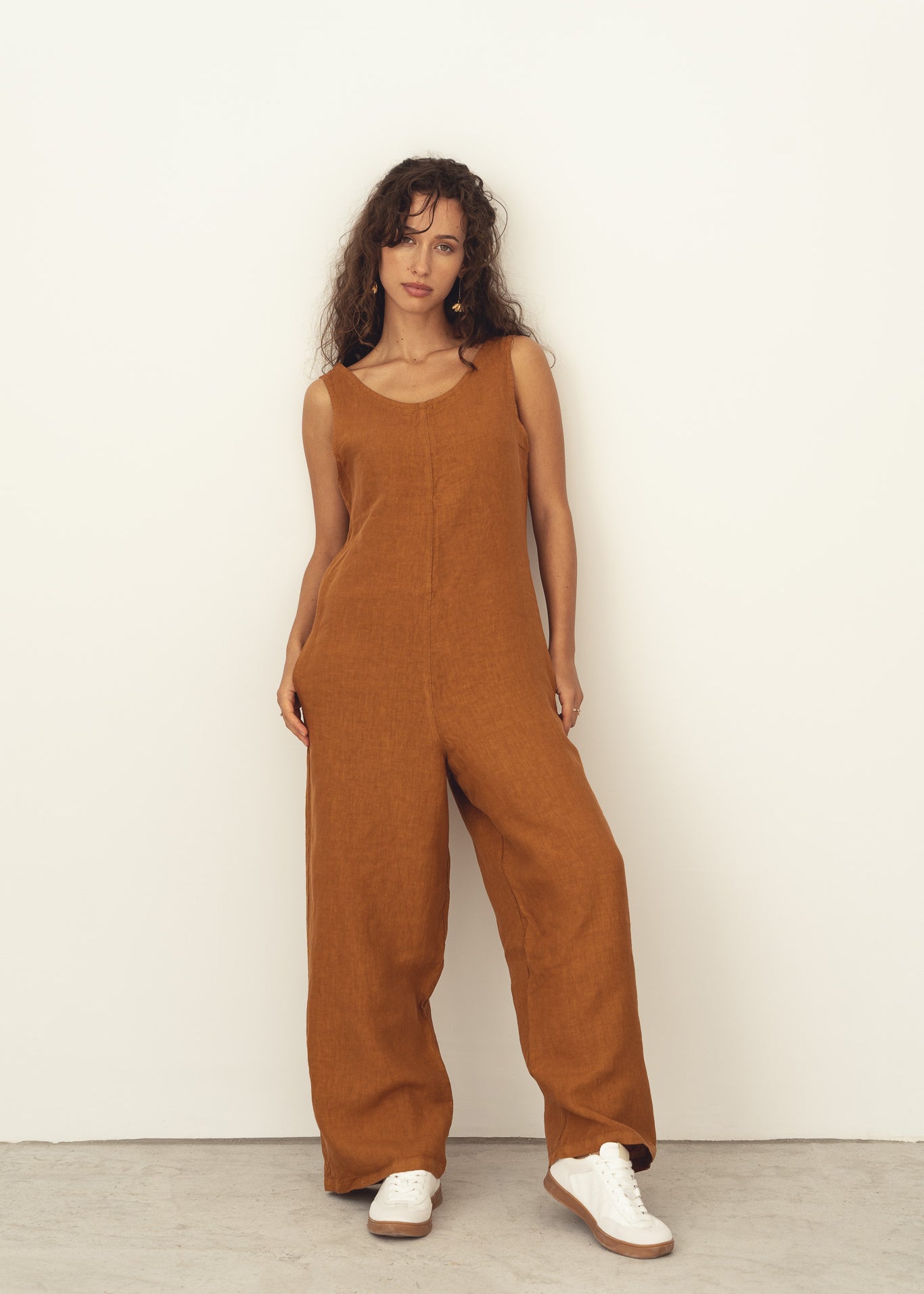 Naz women's breathable linen romper in rust. Features a straight fit and a deep v-neckline. Made in Portugal. 