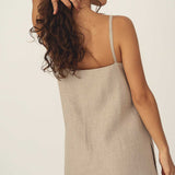 Naz women's sustainable linen midi dress in natural colour. Features v-neckline side pockets and slits on the side. Made in Portugal 
