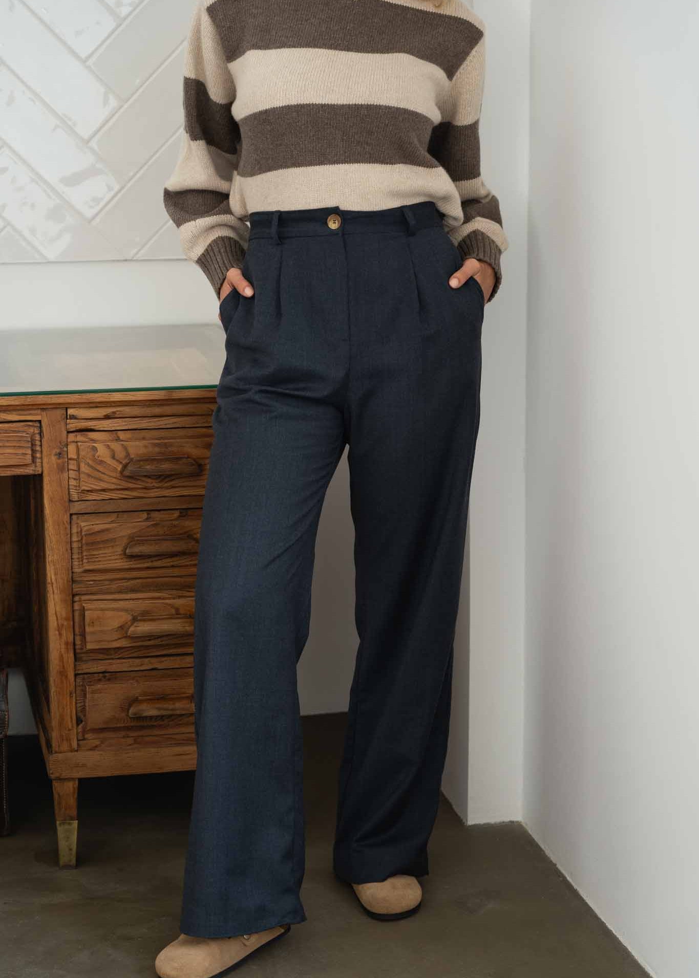 NAZ Mara Trousers in Navy. Made with 100% wool. Produced ethically in Portugal. Paired with the Mia Striped Sweater in Beige.