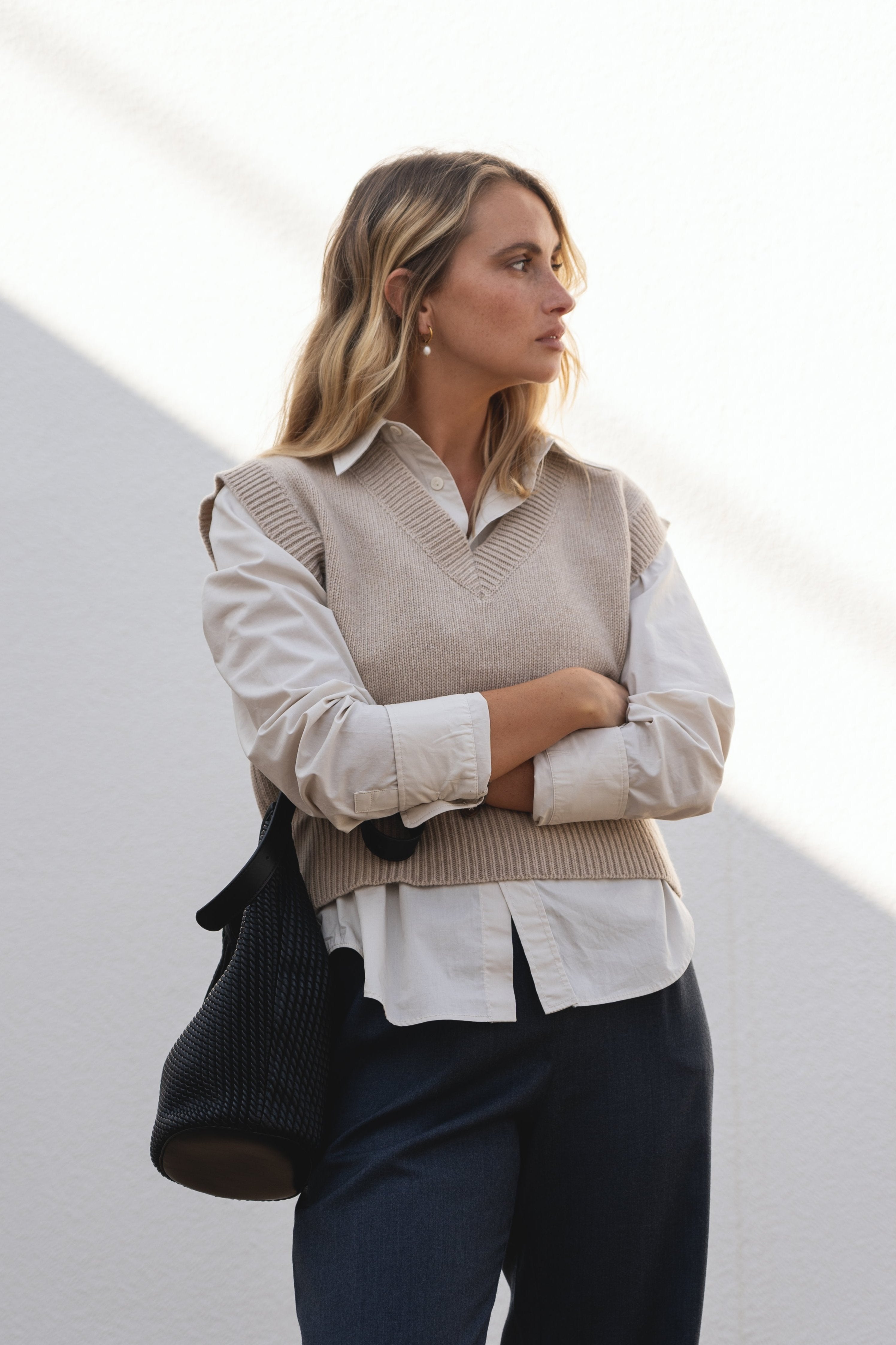 NAZ Alice Knit Vest in Beige. Made with 100% Recycled Wool. Paired with the Mara Wool Trousers in Navy.