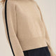 NAZ Agnes Sweater in Beige. Featuring a Navy color block detail. Made with 100% Recycled Wool.