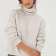 Naz women's turtleneck sweater made from 100% recycled fibers in white. Features an oversized chunky fit. 