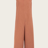 Naz women's jumpsuit in peach. Features a straight fit hidden pockets and deep back v-neckline.
