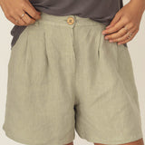 Naz women's sustainable linen shorts made in Portugal. Features a high waisted relaxed fit with hidden pockets in sage green.