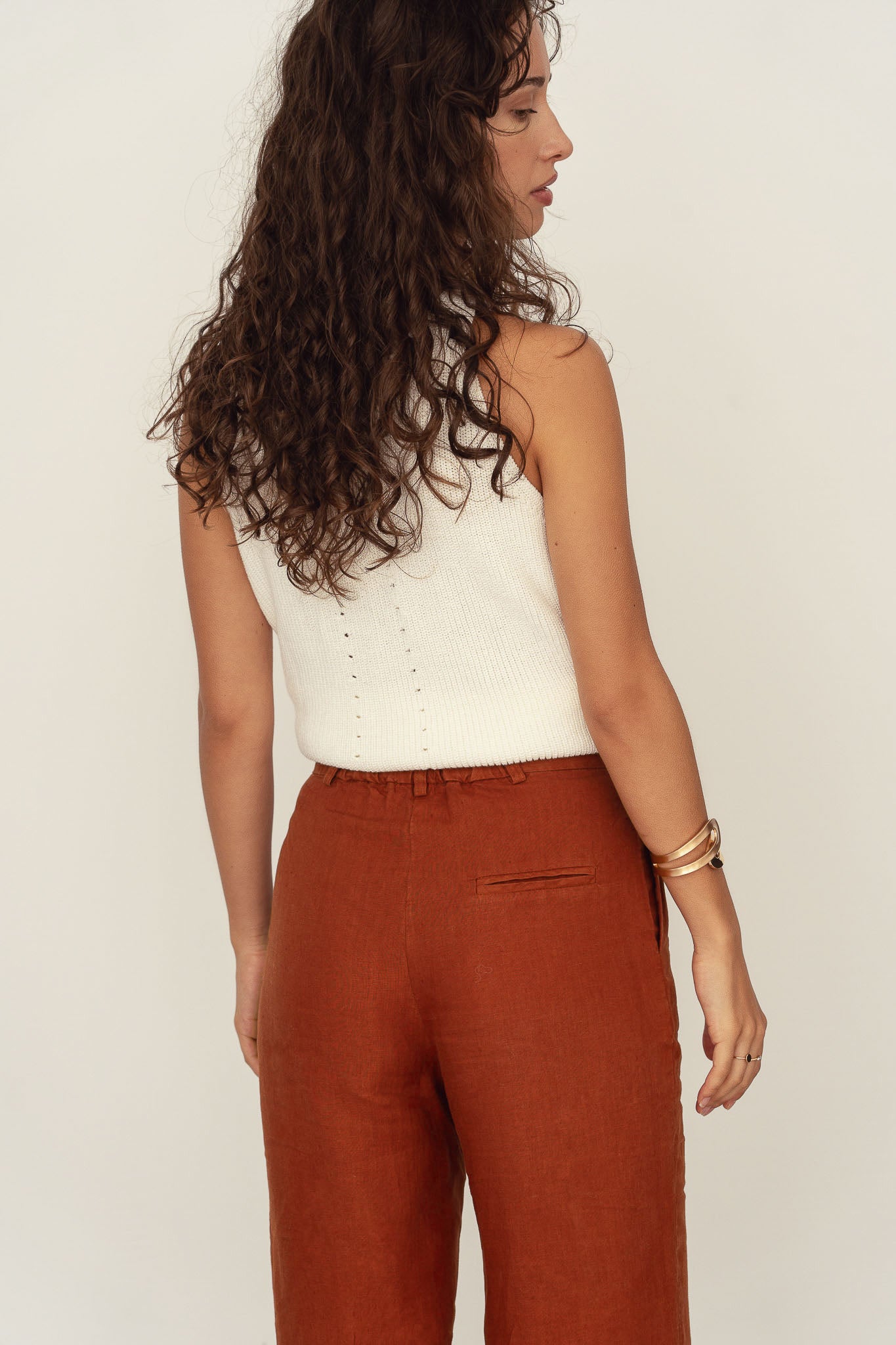 Naz women's tailored linen pants. High-waisted wide leg breathable fabric in rust.