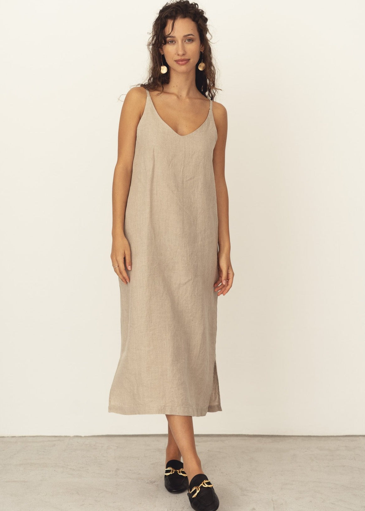 Naz's women's sustainable midi linen dress in beige. Features thin straps, double fabric across the bust with hidden side pockets. 