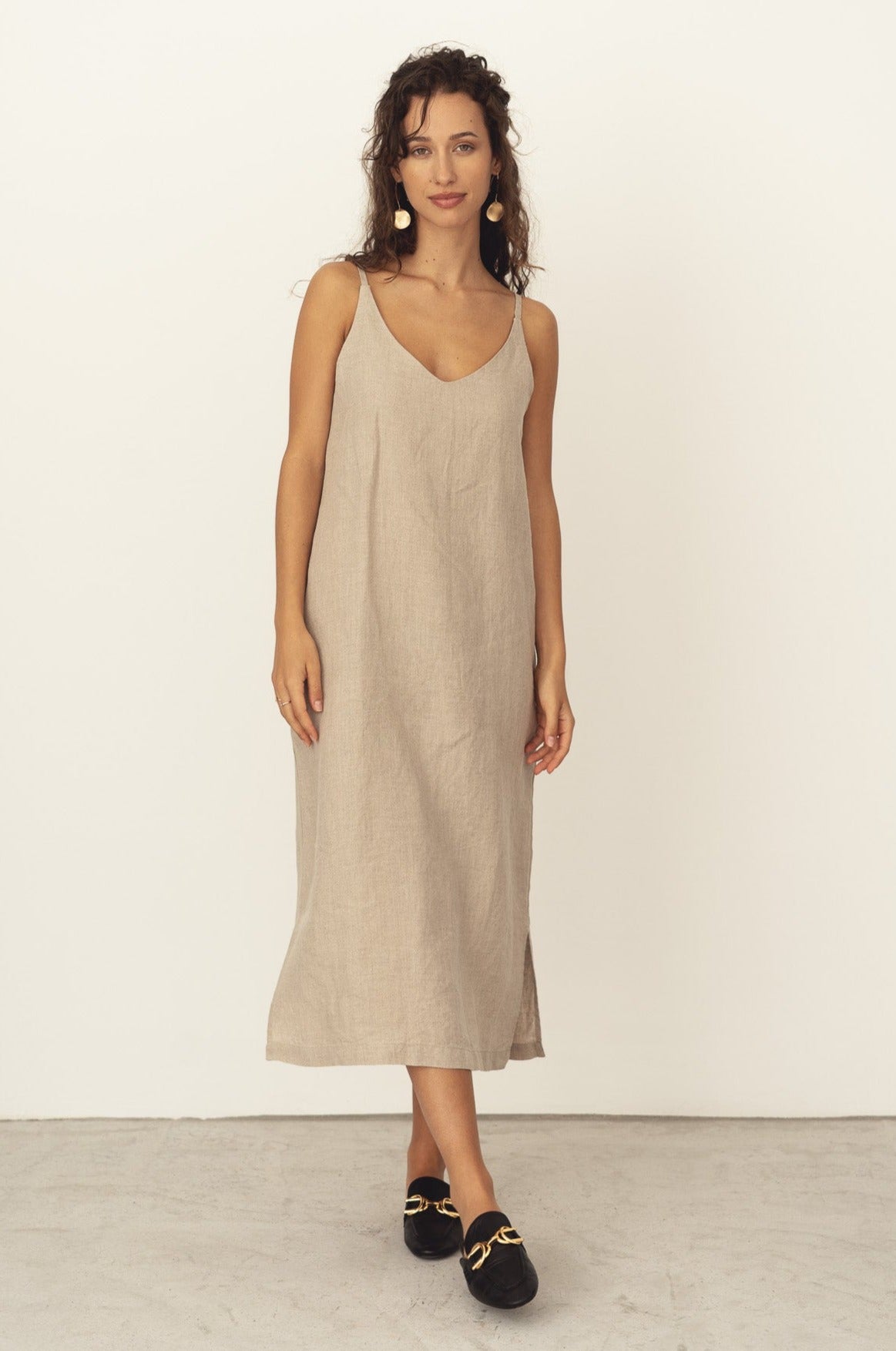 Naz's women's sustainable midi linen dress in beige. Features thin straps, double fabric across the bust with hidden side pockets. 